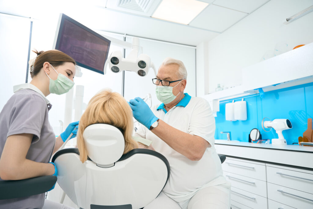 Concentrated orthodontist is helping reduce gum pain in dental clinic