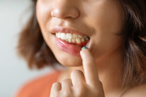Gingivitis Concept. Young Woman Pulling Her Lip And Demonstrating Irritated Gums