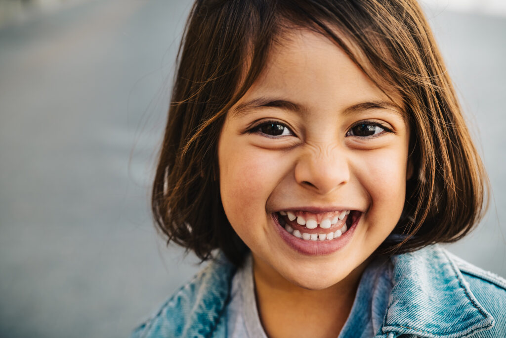 Happy child having fun smiling into the camera