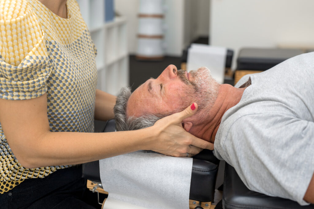 Senior man having chiropractic adjustment.